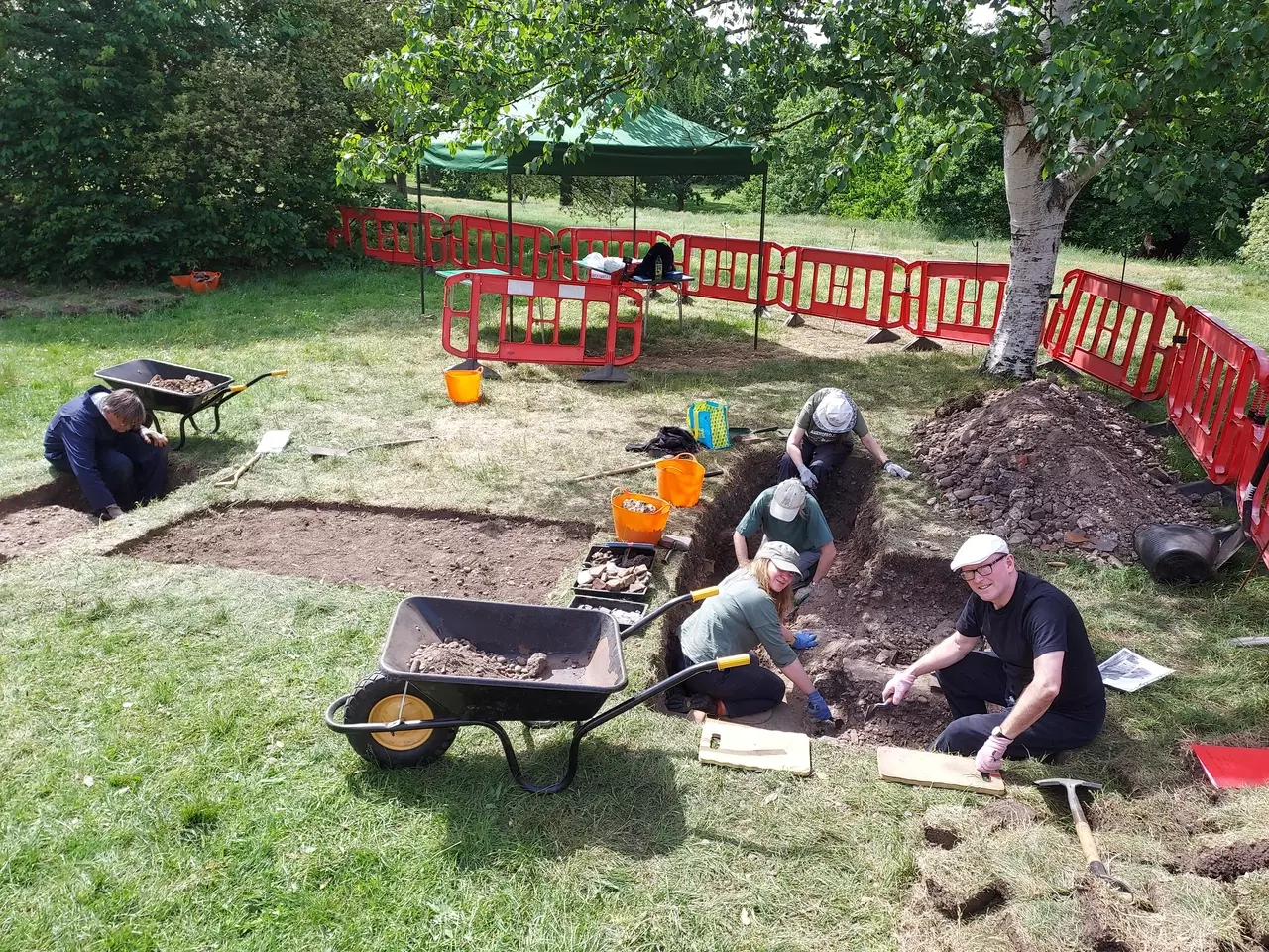 A view of the dig on Day 3. Volunteers are digging the ground around the site.